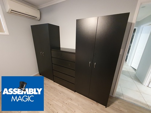 A flat pack wardrobe setup with Assembly Magic logo in bottom left corner