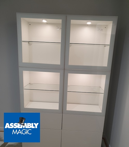 A Wall unit with lighting installed. Assembly Magic logo in bottom left corner