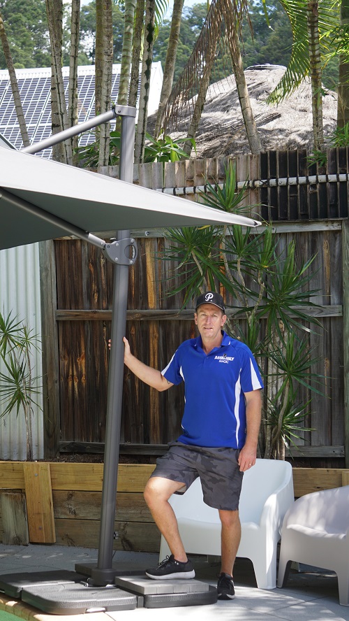 Technician - Ben with an outdoor umbrella he installed