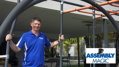 Technician - Brendan, with a Play Gym he assembled. Logo in bottom right corner.