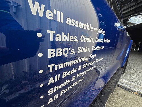 Your local Assembly Handyman's listed services on the side of his vehicle.