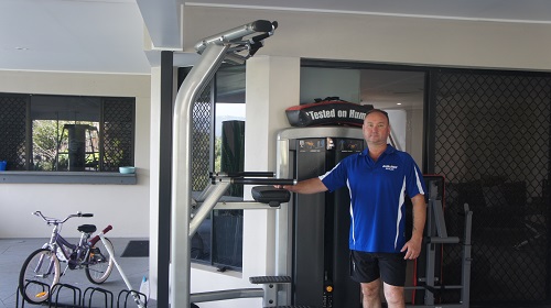 Technician with newly assembled Gym Equipment. Assembly Magic logo in bottom right corner