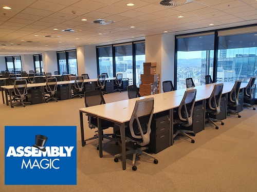Large conference room setup with Assembly Magic logo in bottom left corner