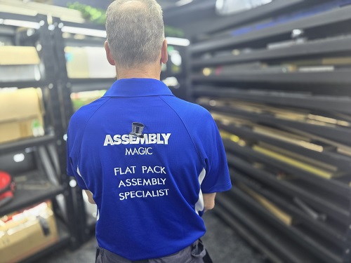 Technician showing the back of his shirt.