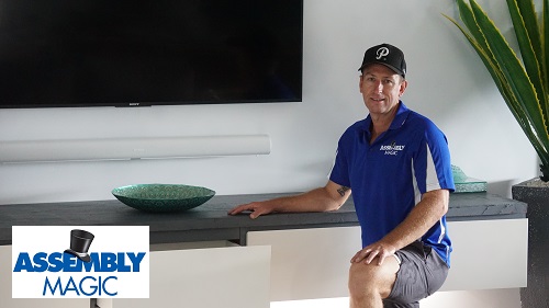 Technician in front of a floating cabinet with Assembly Magic logo in bottom left corner