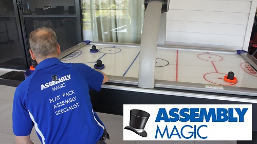 Technician setting up an air hockey table. Logo in bottom right corner