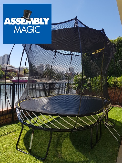 Large trampoline assembly by Assembly Magic with safety netting and shade