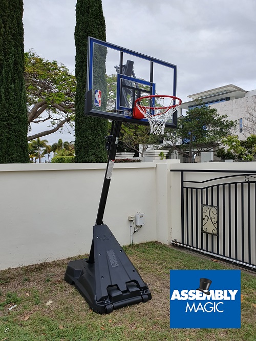 Large portable basketball hoop newly assembled. Assembly Magic logo in bottom right corner