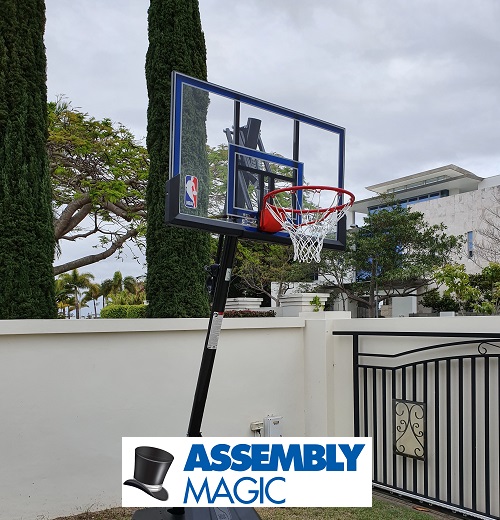 Large basketball hoop assembled by Assembly Magic. Logo bottom middle