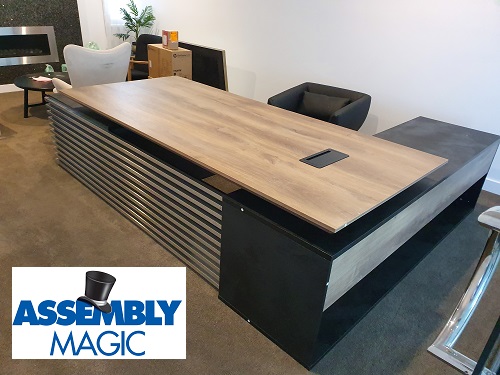 Large office desk assembled by Assembly Magic. Assembly Magic logo in bottom left corner