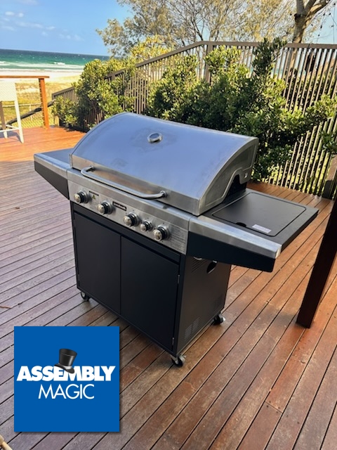 BBQ on a deck besdie the beach with Assembly Magic Logo