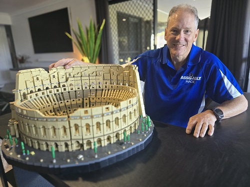 Technician with a Colosseum Lego he assembled.