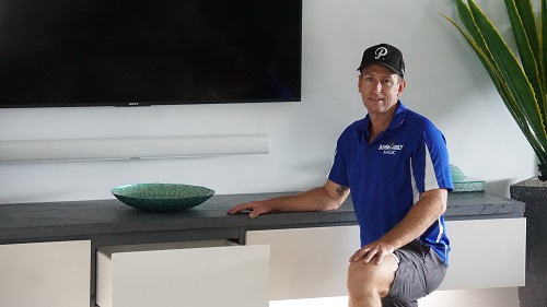 technician - Ben in front of a floating cabinet